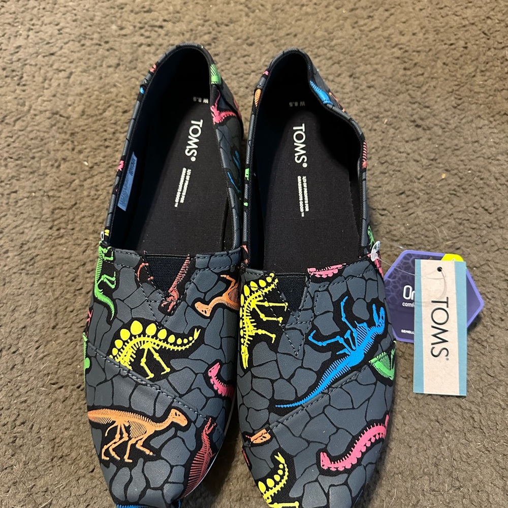 NWT Women’s size 8.5 TOMS Sneakers with Dinosaur Design - Black and Multi